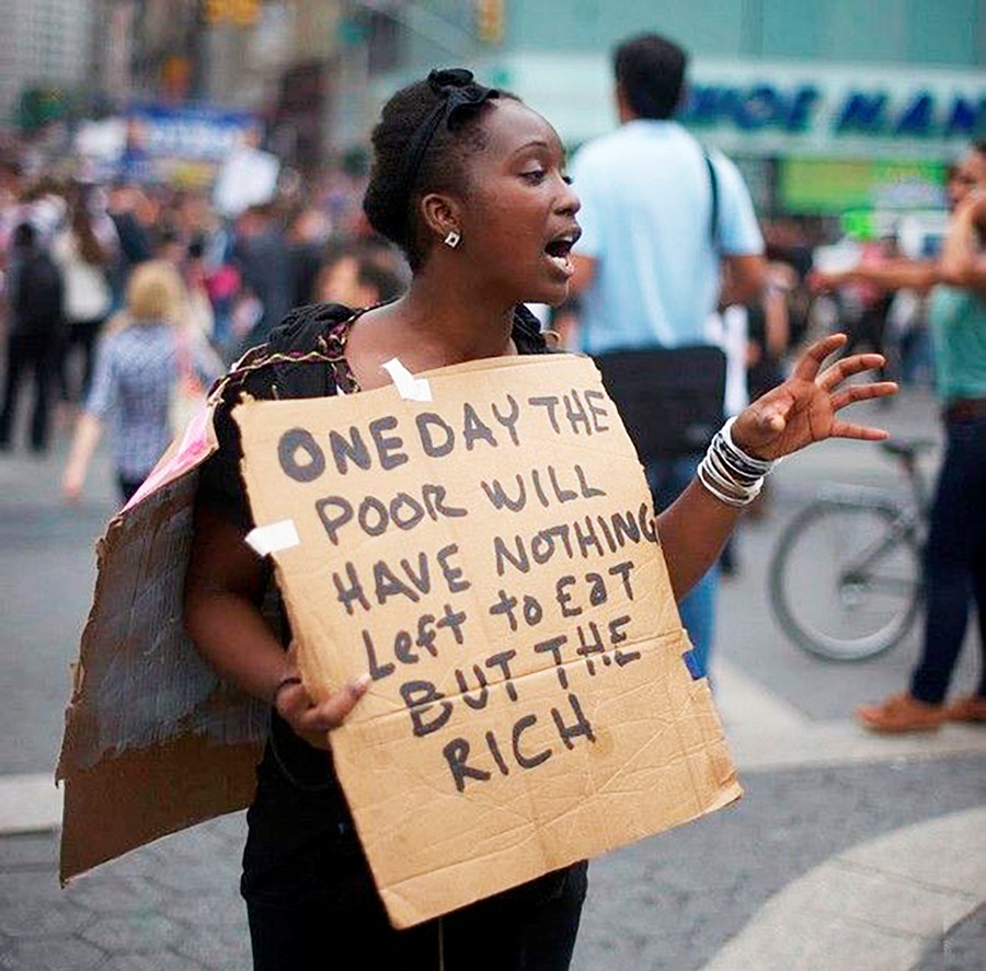 Mótmælaspjald þessarar konu er mjög táknræn fyrir stöðuna. Á því stendur að einn daginn muni þeir fátæku ekki hafa neitt eftir til að borða nema þá ríku.